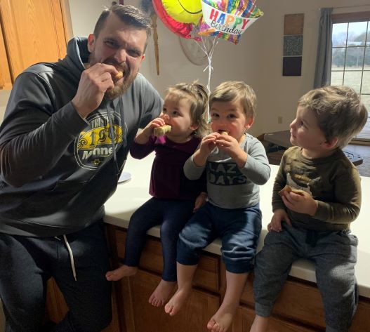 Employee pictured enjoying homemade bagels with his children