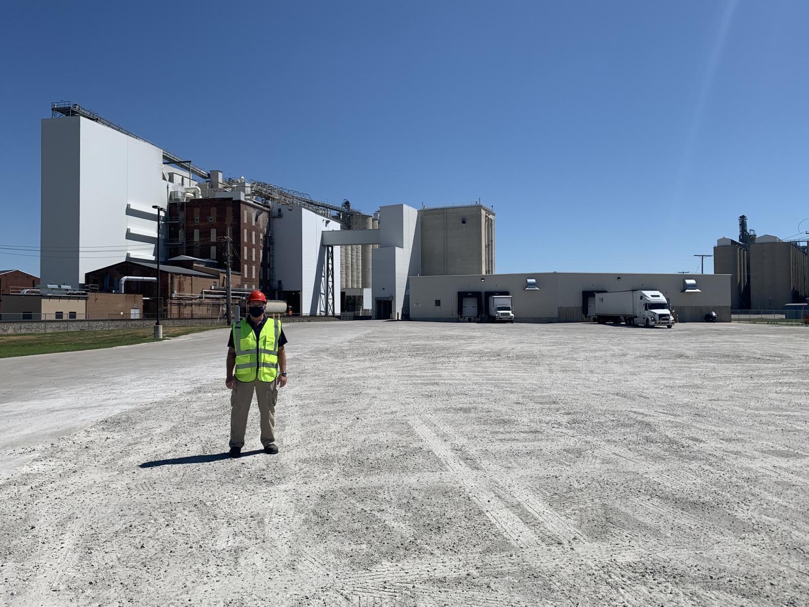 Employee marks the site of the warehouse expansion in Fostoria