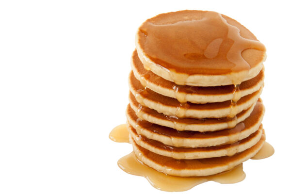 Stack of pancakes drizzled with maple syrup