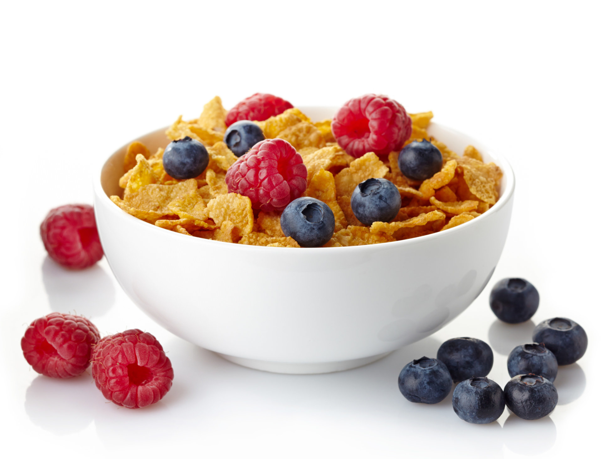 Bowl of whole grain cereal topped with berries