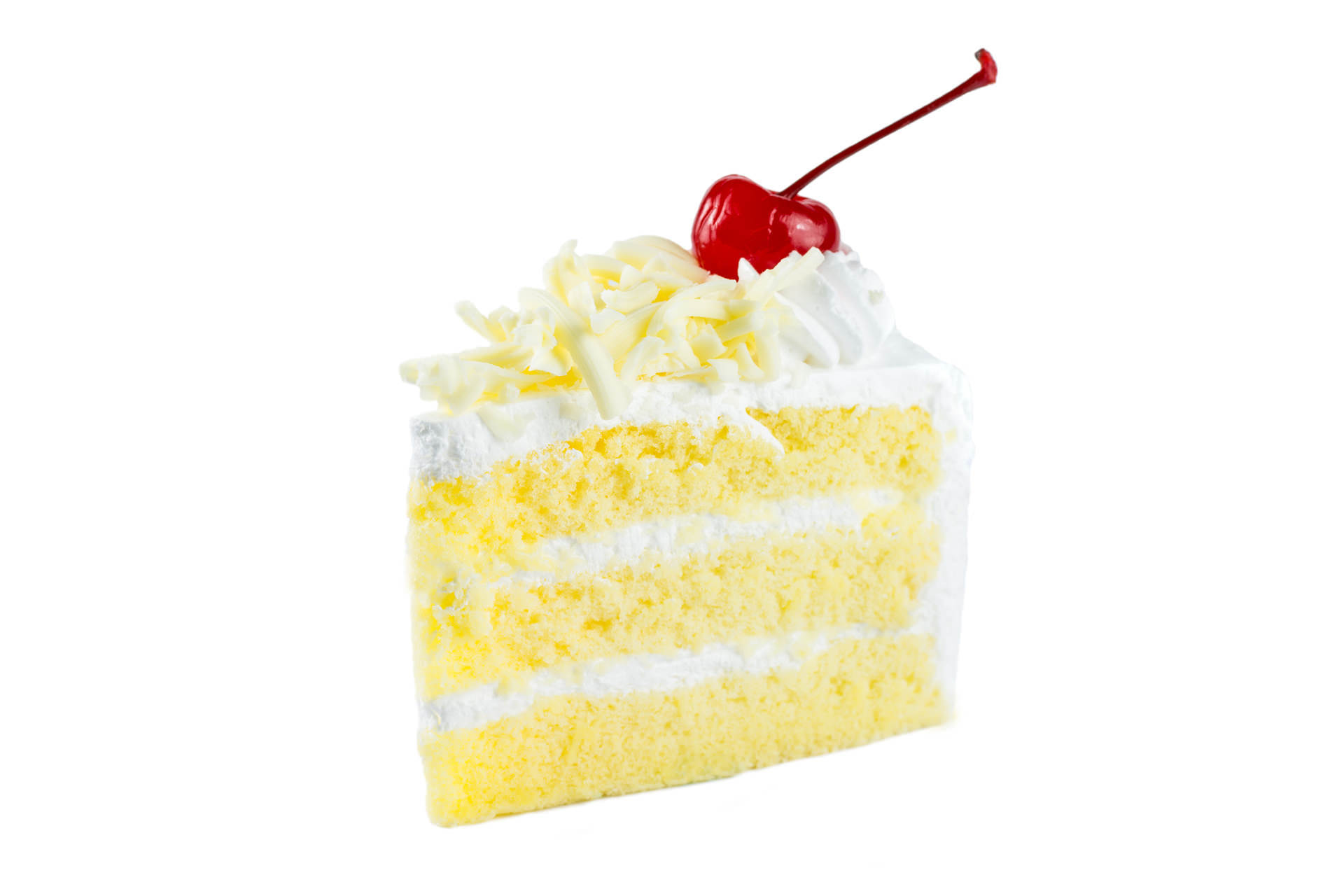 Slice of white layer cake topped with frosting and a cherry