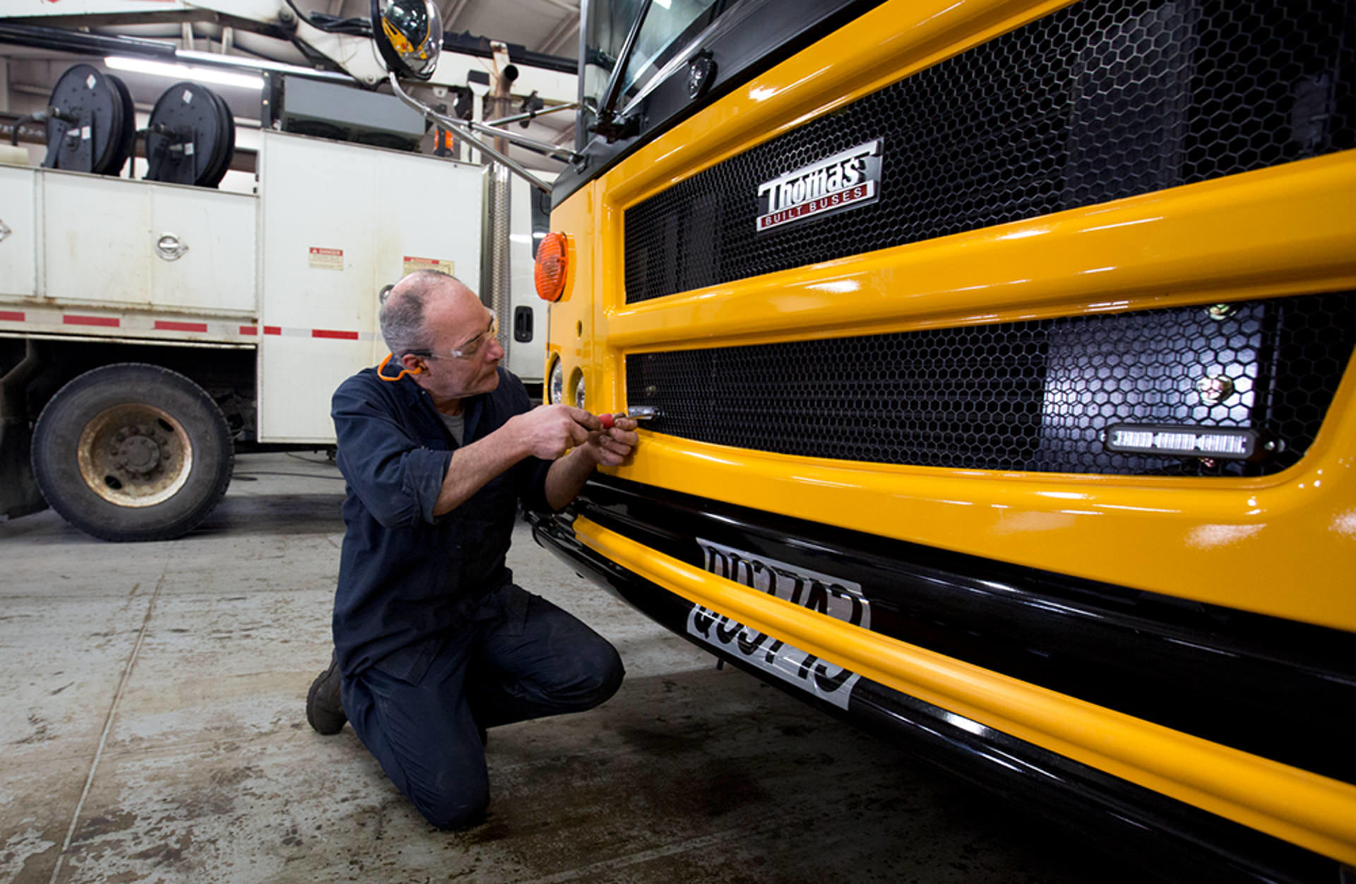 Mechanic works on school bus